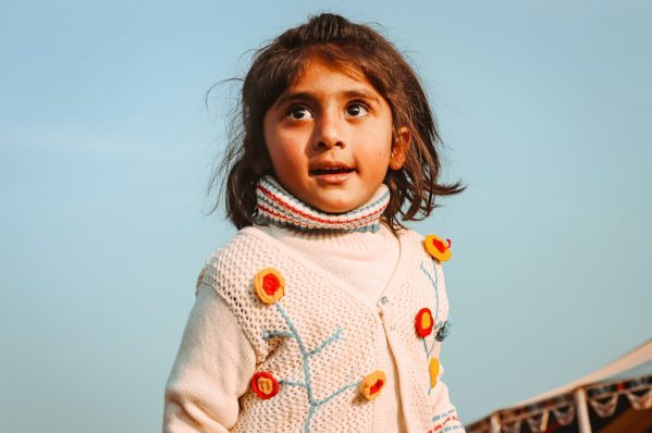 girl in white and pink heart print sweater