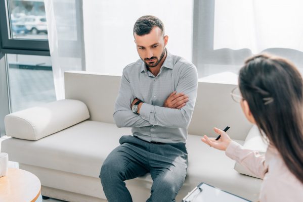 psychologist and patient talking in clinic, mental health concept